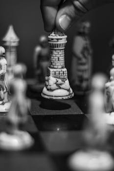 Black and white chess scene with a rook being strategically moved on the board.